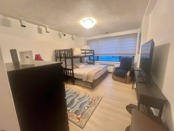 a bedroom with furniture and a flat screen tv