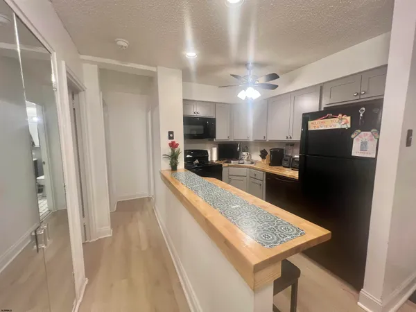 a kitchen with stainless steel appliances granite countertop a refrigerator a sink and a stove