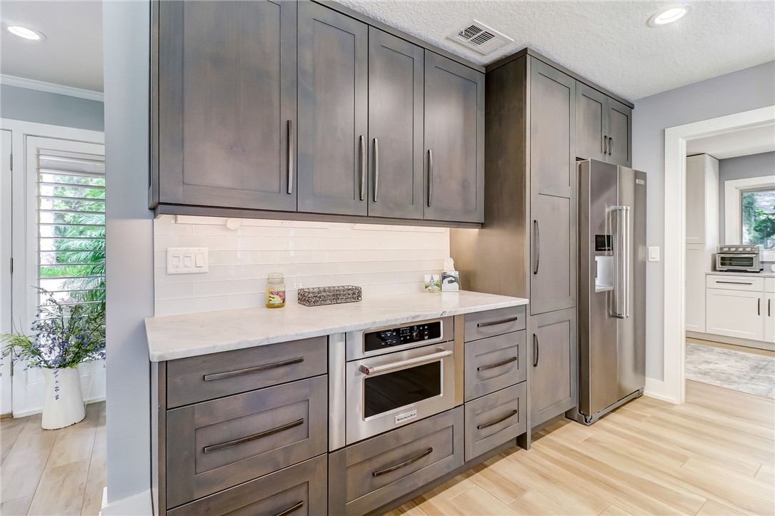 75 Sea Marsh Road Fernandina Beach, FL 32034 - Photo 12 of 30 a kitchen with stainless steel appliances granite countertop cabinets and wooden floor