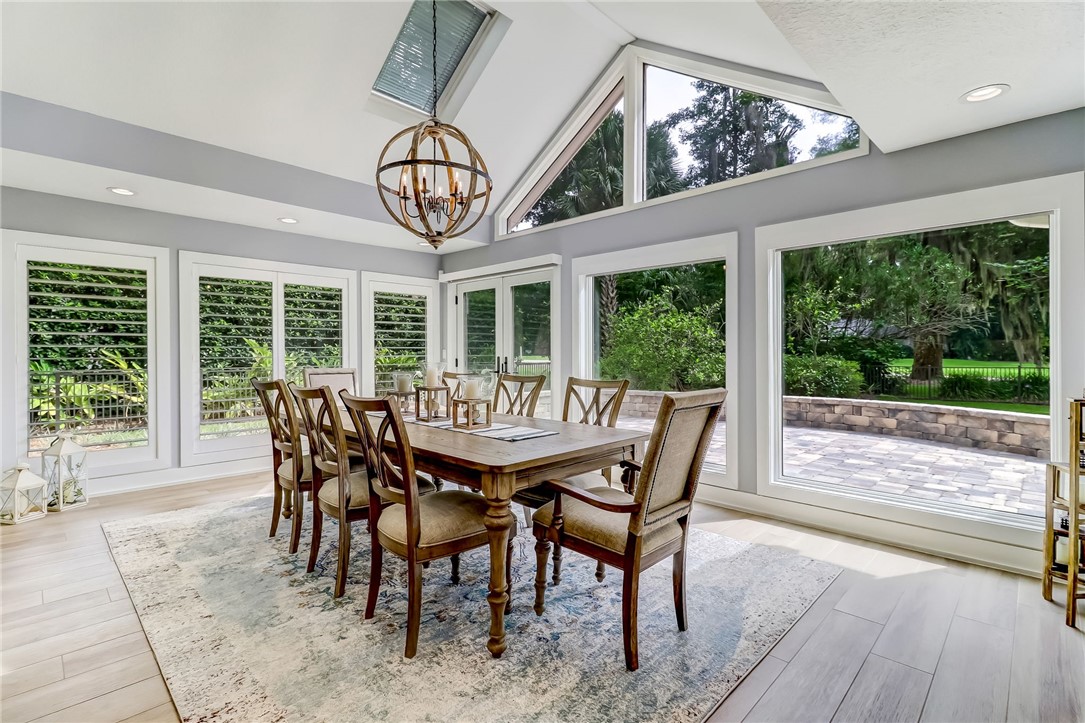 75 Sea Marsh Road Fernandina Beach, FL 32034 - Photo 14 of 30 a view of a dining room with furniture wooden floor and chandelier