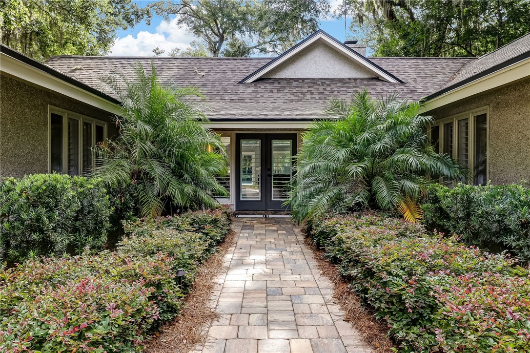 75 Sea Marsh Road Fernandina Beach, FL 32034 - Photo 3 of 30 a view of brick house with potted plants