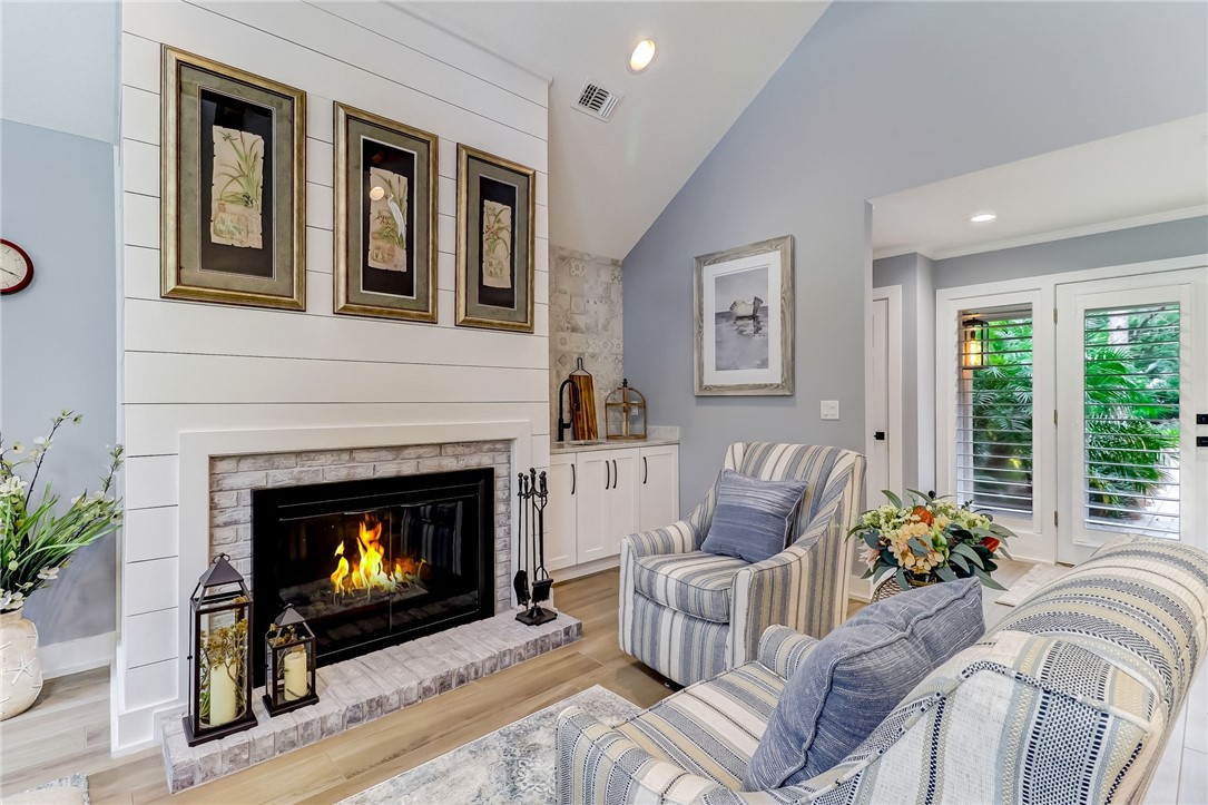 75 Sea Marsh Road Fernandina Beach, FL 32034 - Photo 5 of 30 a living room with furniture a window and a fireplace