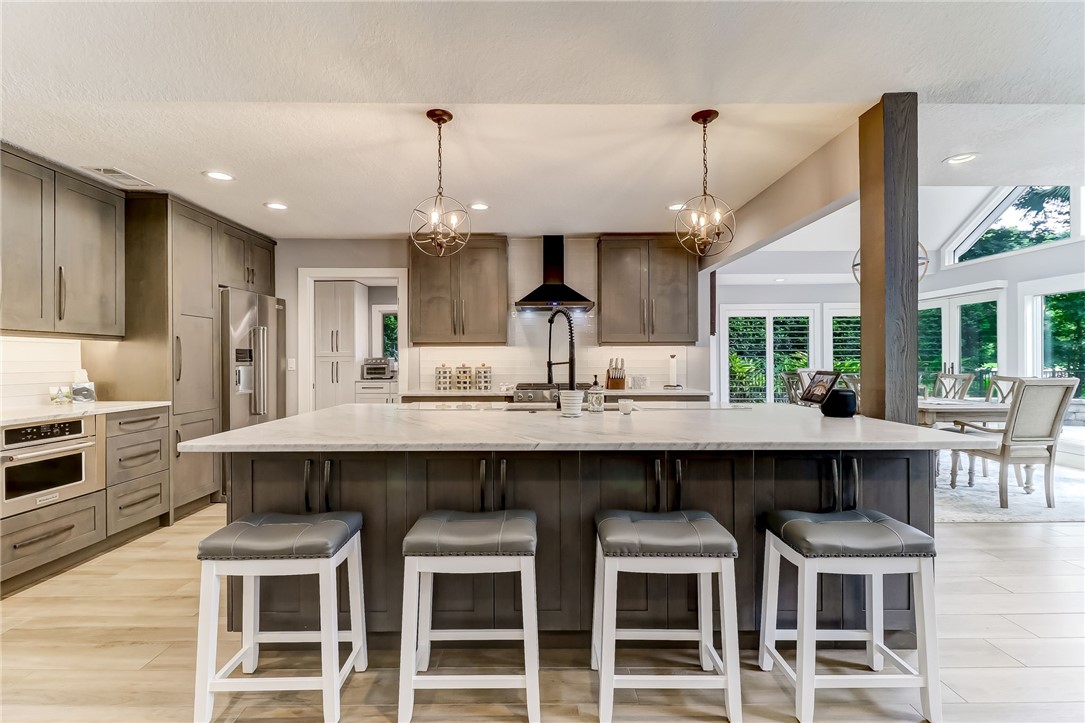 75 Sea Marsh Road Fernandina Beach, FL 32034 - Photo 9 of 30 a kitchen with a table chairs stove and cabinets