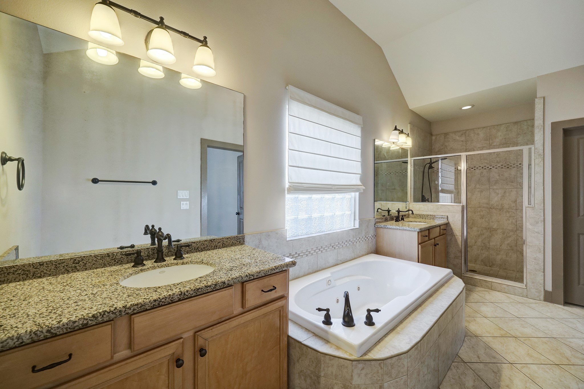 953 Patterson Street Houston, TX 77007 - Photo 11 of 14 a bathroom with a granite countertop tub sink and mirror