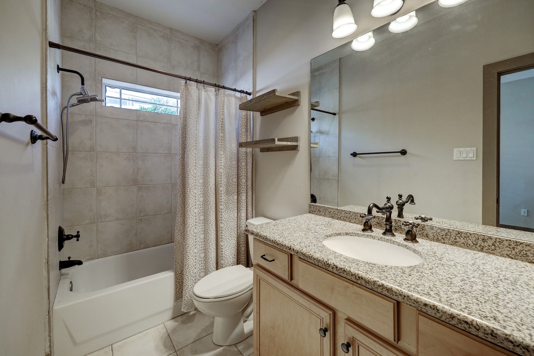 953 Patterson Street Houston, TX 77007 - Photo 4 of 14 a bathroom with a granite countertop sink toilet and shower