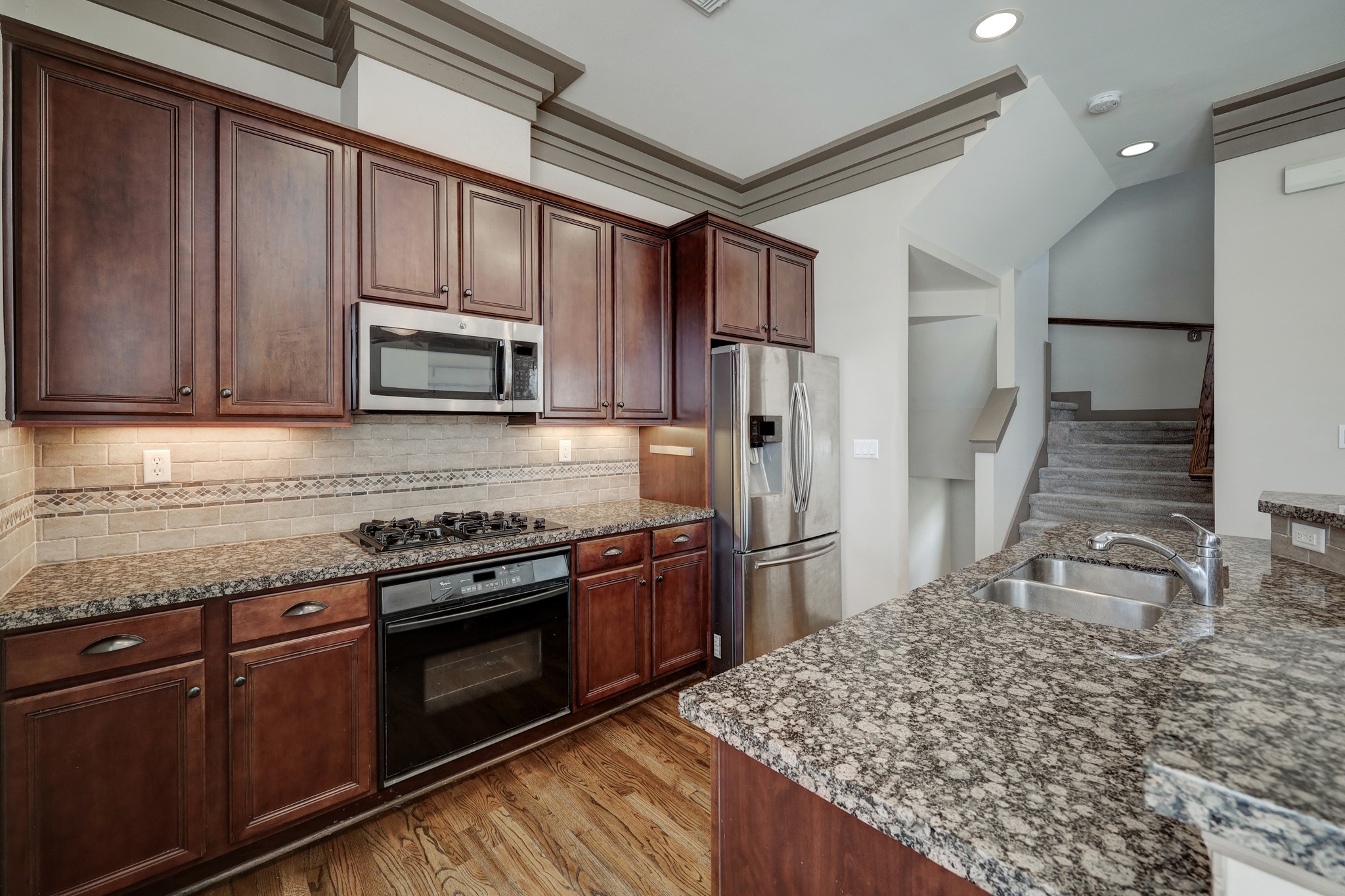 953 Patterson Street Houston, TX 77007 - Photo 5 of 14 a kitchen with stainless steel appliances granite countertop a stove microwave and refrigerator