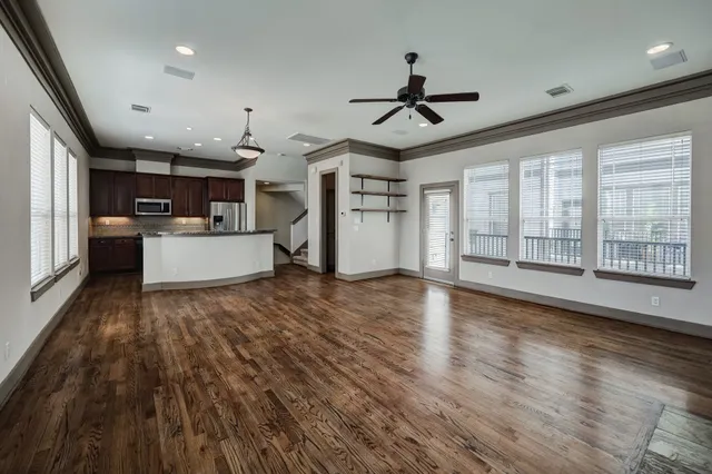 a view of empty room with wooden floor and fireplace