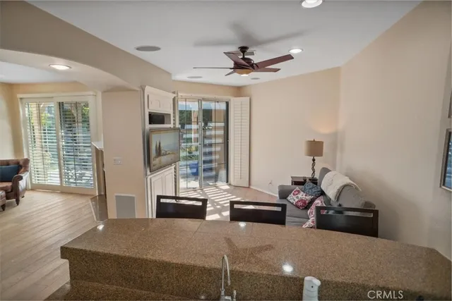 a bedroom with a bed chandelier and a window
