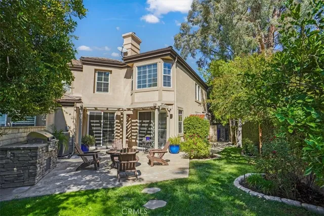 a swimming pool with outdoor seating and green space