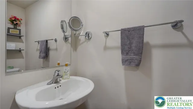 a bathroom with a sink and mirror