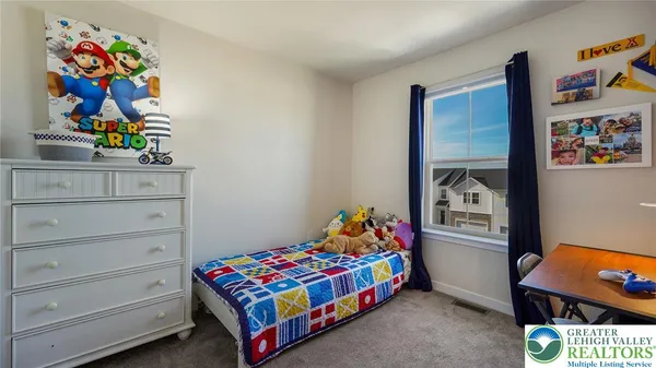 a bedroom with a bed and painting on the wall