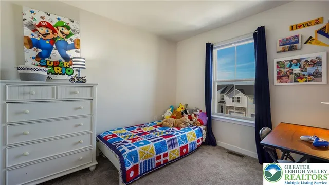 a bedroom with a bed and painting on the wall