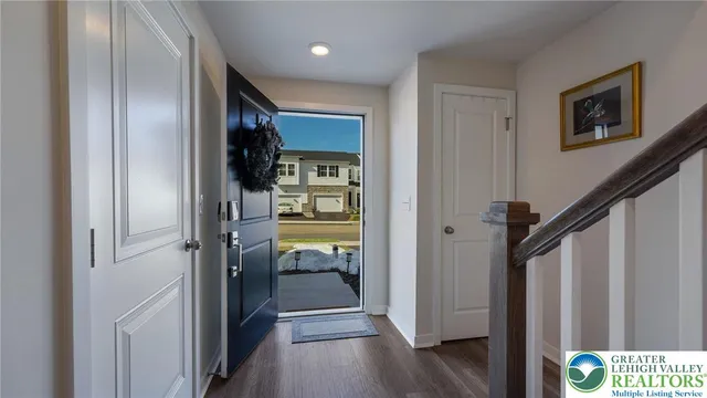 a view of a hallway with wooden floor and closet area