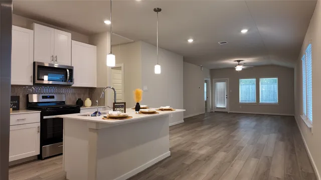a kitchen with a sink stainless steel appliances and cabinets