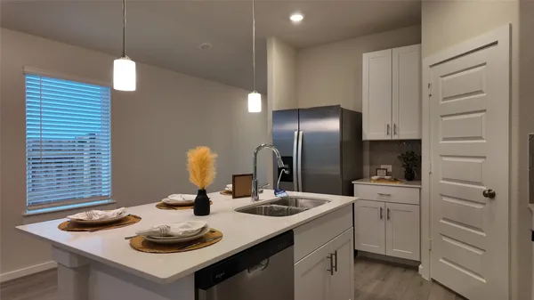 a kitchen with a sink cabinets and appliances