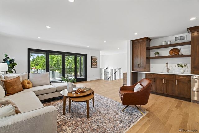 a living room with furniture and view of kitchen