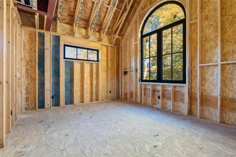 a view of an empty room with large windows