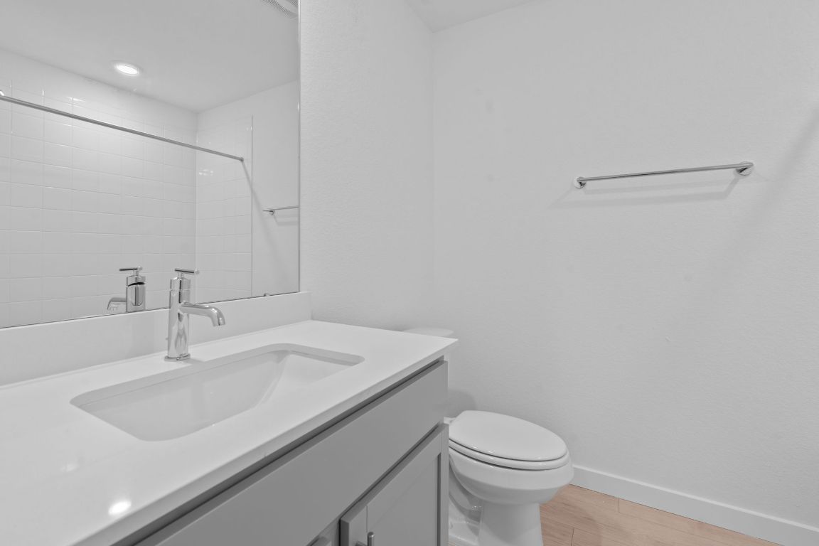 9704 Oxbow Strap Drive Austin, TX 78724 - Photo 18 of 22 a bathroom with a sink toilet and a mirror