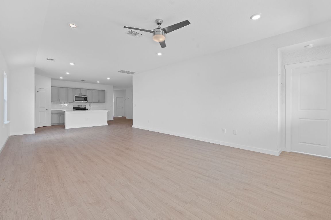 9704 Oxbow Strap Drive Austin, TX 78724 - Photo 5 of 22 an empty room with a kitchen