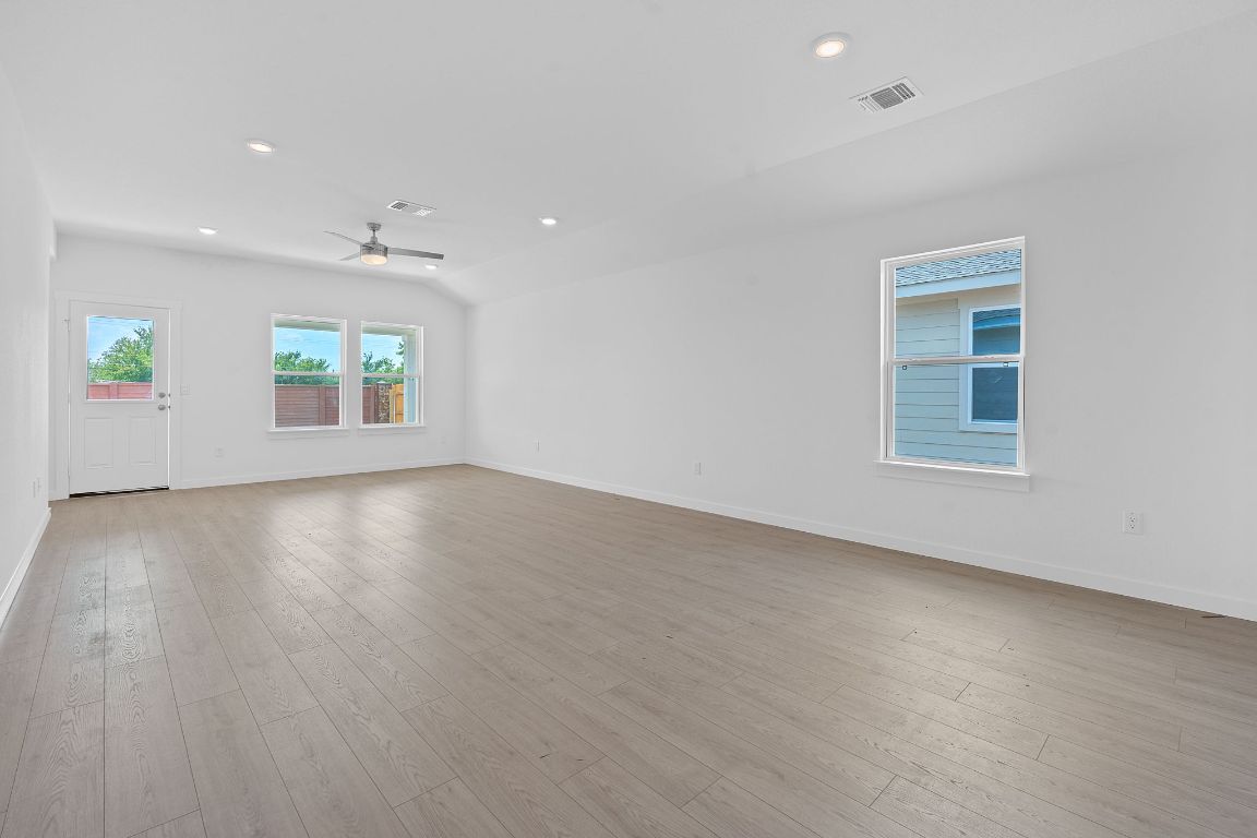 9704 Oxbow Strap Drive Austin, TX 78724 - Photo 7 of 22 an empty room with wooden floor and windows