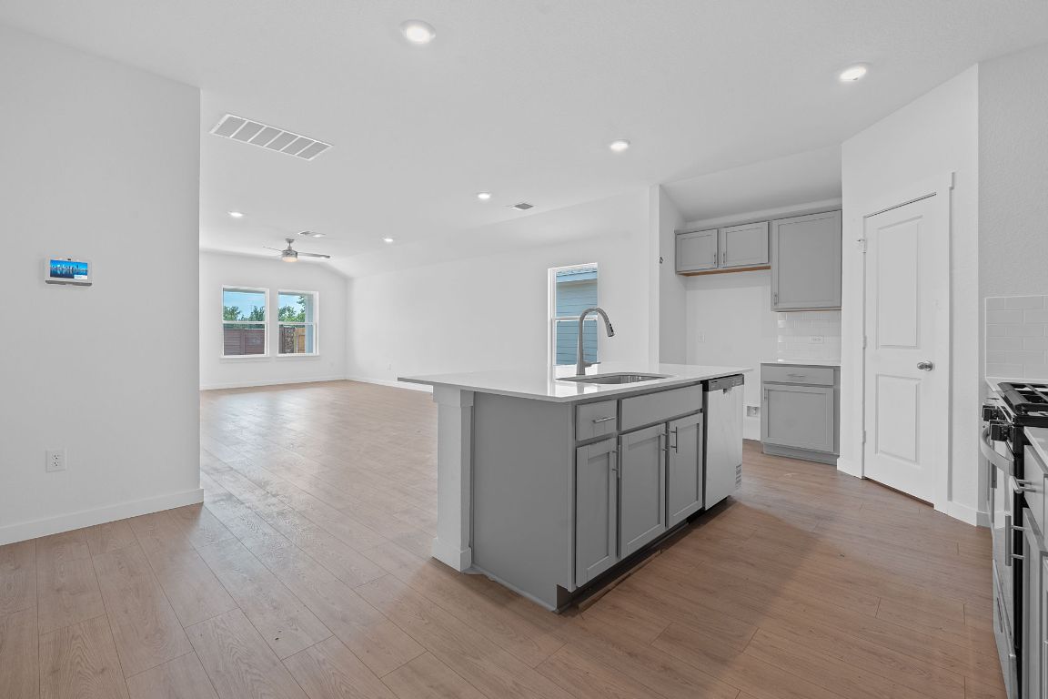 9704 Oxbow Strap Drive Austin, TX 78724 - Photo 9 of 22 a kitchen with a white wooden cabinets and white stainless steel appliances