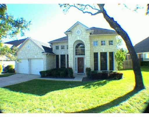 a front view of a house with a yard and porch