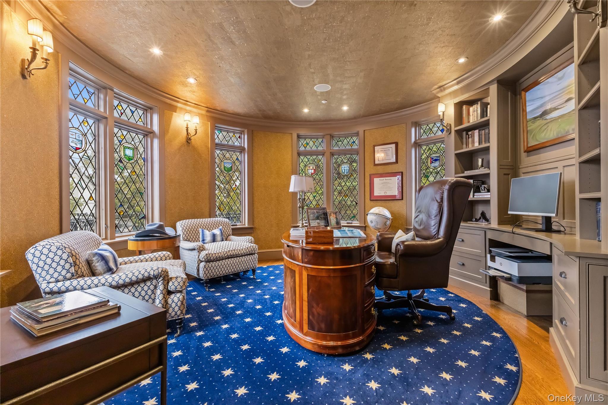 19 Park Drive South Rye, NY 10580 - Photo 12 of 42 Sophisticated home office featuring a curved wall of stunning stained-glass windows that fill the space with natural light and architectural charm. Custom built-ins, elegant finishes, and a distinctive round layout create an inspiring and refined workspace.