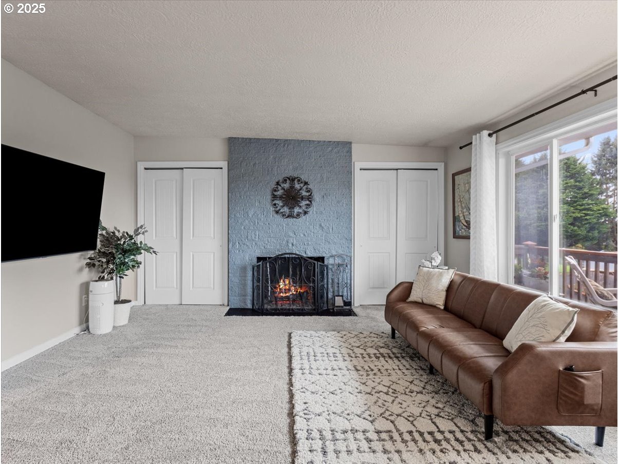 2102 Kelly Road, Unit 3 Vancouver, WA 98665 - Photo 5 of 20 a living room with furniture a fireplace and a flat screen tv
