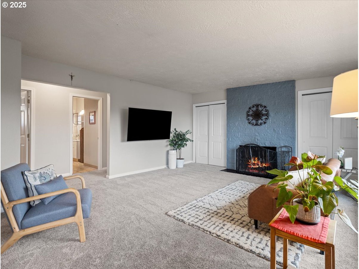 2102 Kelly Road, Unit 3 Vancouver, WA 98665 - Photo 6 of 20 a living room with furniture a flat screen tv and a fireplace
