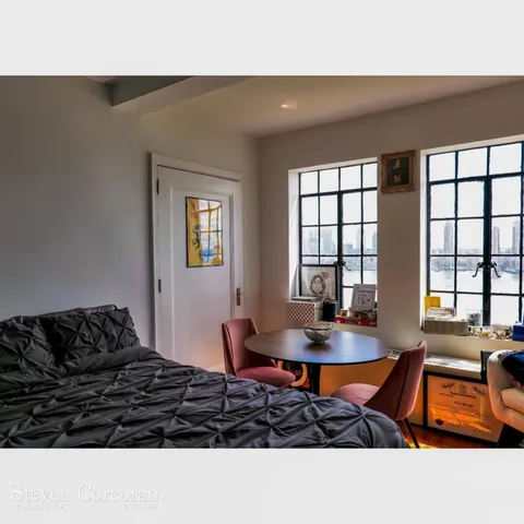 a hallway with wooden floors and wide window