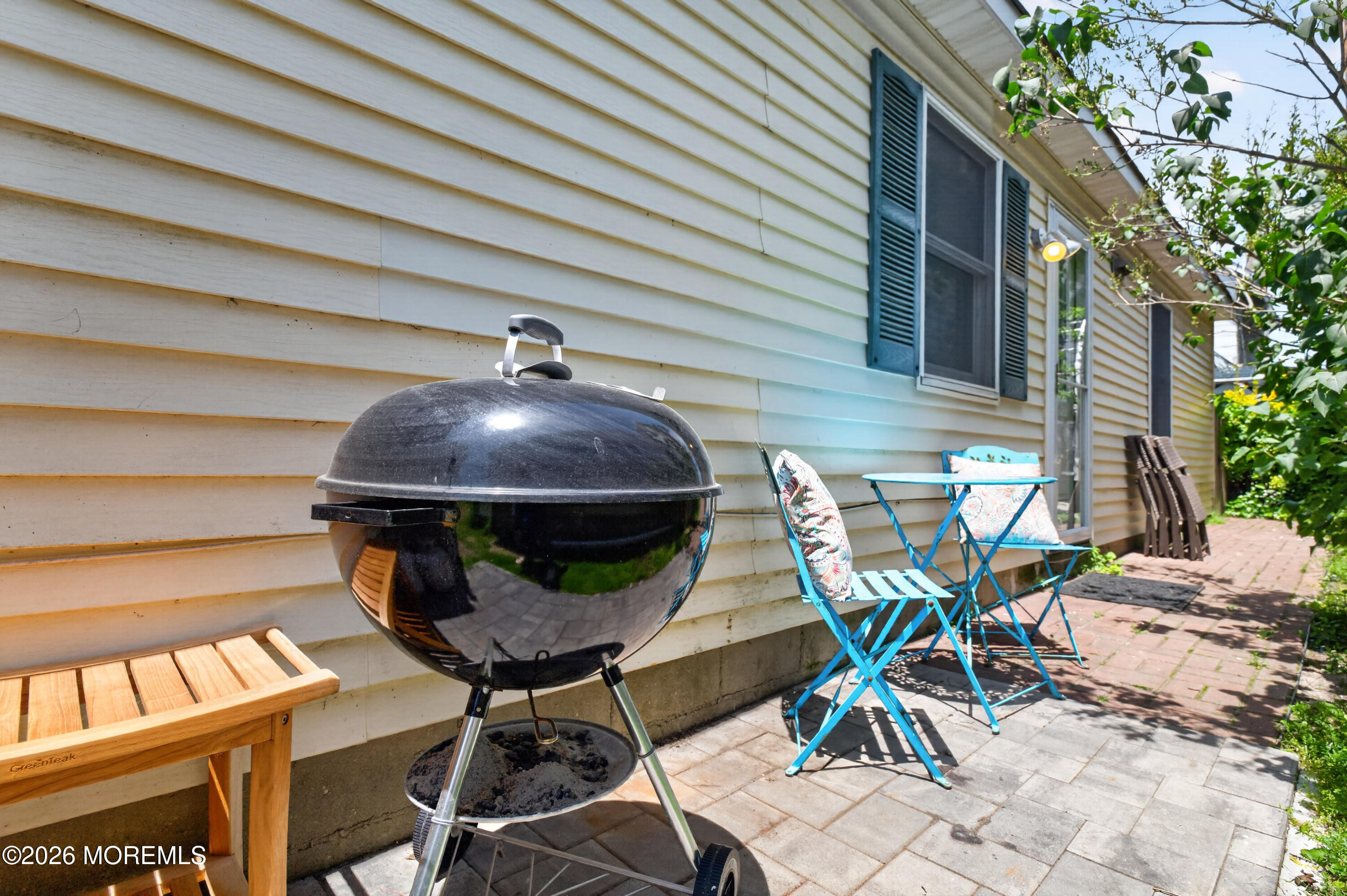 65 Heck Avenue Ocean Grove, NJ 07756 - Photo 29 of 37 a table and chairs in front of a house