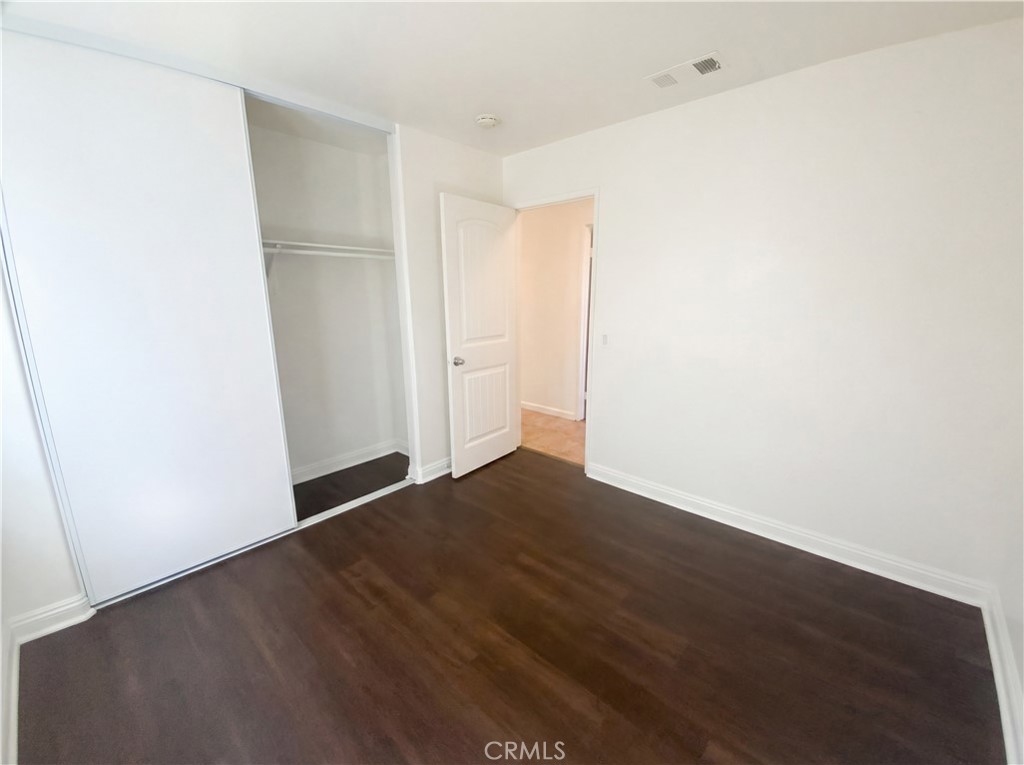 14433 Green River Road Victorville, CA 92394 - Photo 13 of 27 a view of an empty room with wooden floor