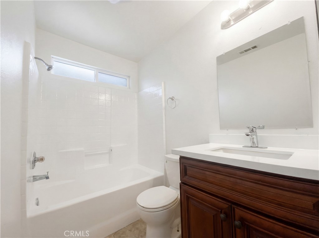 14433 Green River Road Victorville, CA 92394 - Photo 17 of 27 a bathroom with a sink a toilet and a large mirror