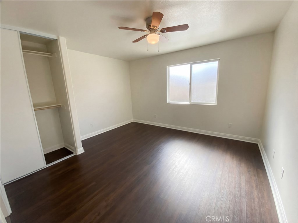 14433 Green River Road Victorville, CA 92394 - Photo 20 of 27 an empty room with wooden floor and windows