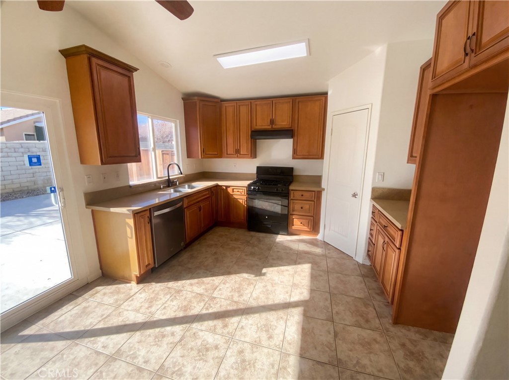 14433 Green River Road Victorville, CA 92394 - Photo 2 of 27 a kitchen with a sink stove and cabinets