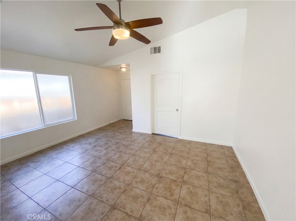 14433 Green River Road Victorville, CA 92394 - Photo 26 of 27 an empty room with a ceiling fan and window