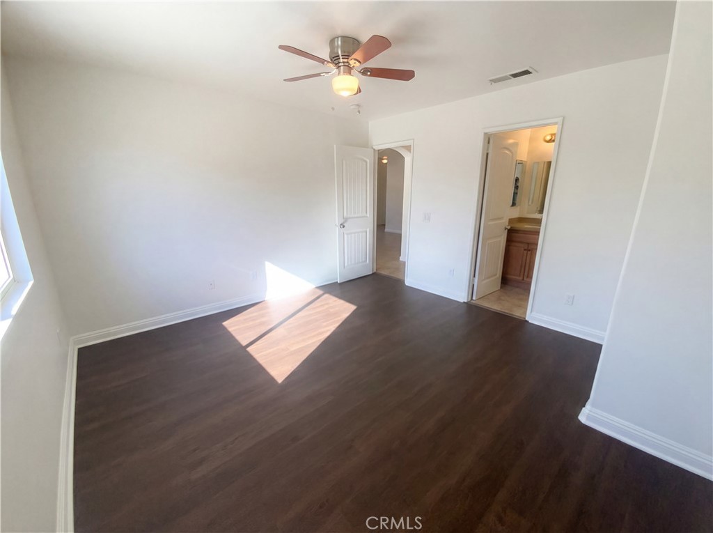 14433 Green River Road Victorville, CA 92394 - Photo 4 of 27 wooden floor in an empty room with a window