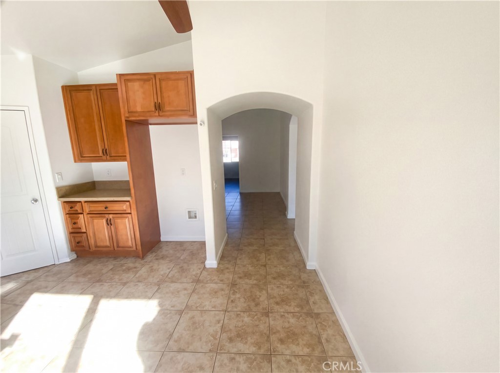 14433 Green River Road Victorville, CA 92394 - Photo 8 of 27 a view of a hallway with wooden shelves