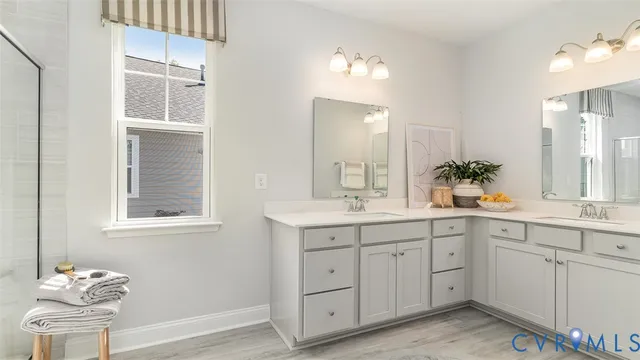 a spacious bathroom with a double vanity sink mirror and next to a window