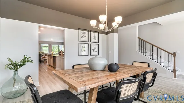 a view of a dining room with furniture wooden floor and chandelier