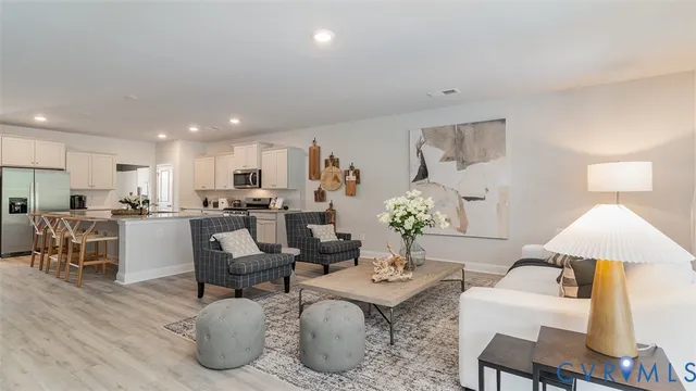 a living room with furniture kitchen view and a table