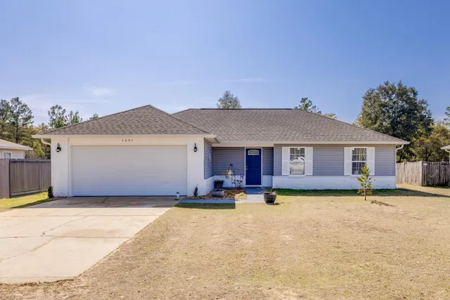 a front view of a house with a yard and fire pit