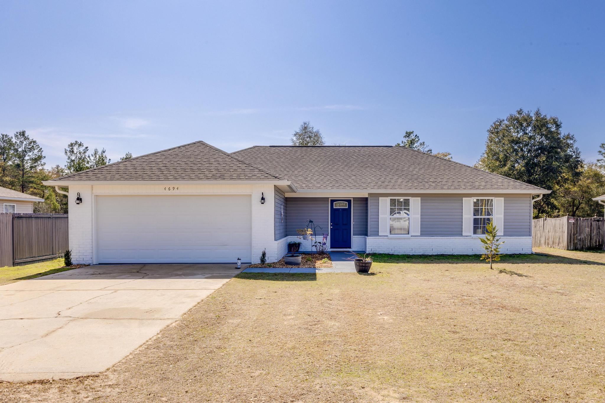 4694 Bobolink Way Crestview, FL 32539 - Photo 14 of 16 a front view of a house with a yard and fire pit