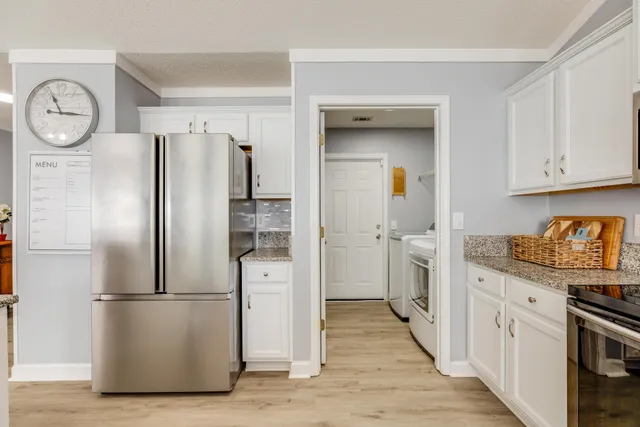 a kitchen with stainless steel appliances a refrigerator a stove and cabinets