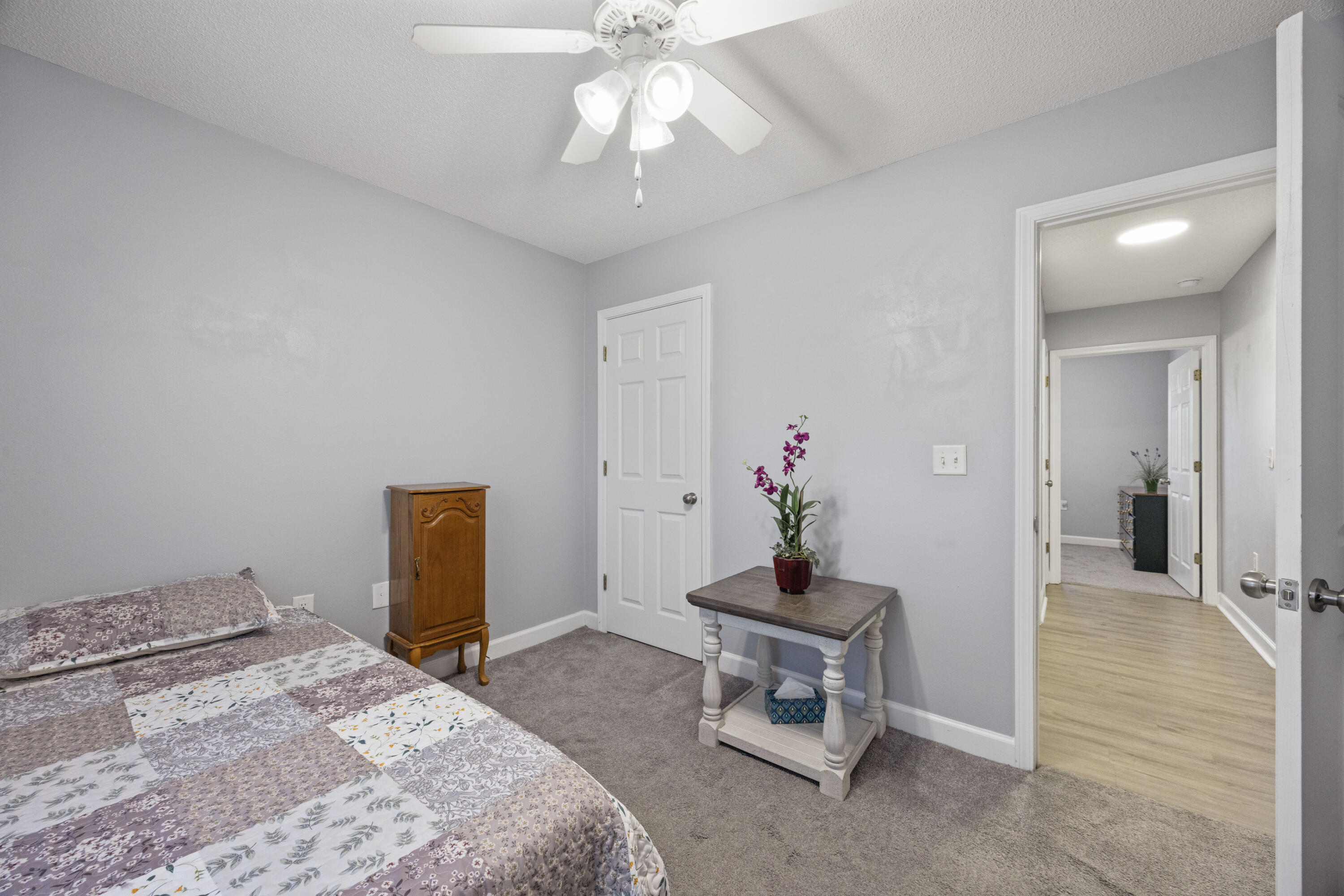 4694 Bobolink Way Crestview, FL 32539 - Photo 9 of 16 a bedroom with a bed and a chandelier