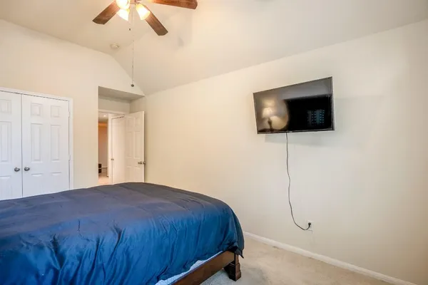 a bedroom with a bed and chandelier