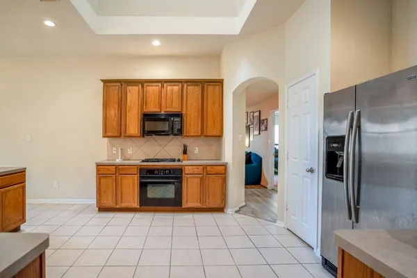a large kitchen with stainless steel appliances granite countertop a sink and cabinets