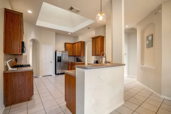 a kitchen with stainless steel appliances granite countertop a sink a counter space and cabinets