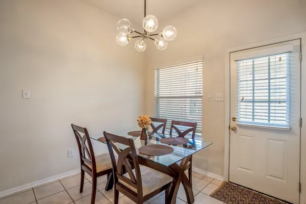 a view of a dining room with furniture and a chandelier