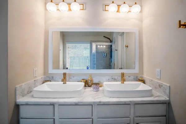 a bathroom with a tub sink and mirror